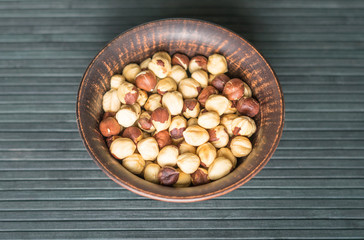 Healthy food  for background image close up hazelnuts.  Nuts texture on top view on the cup plate