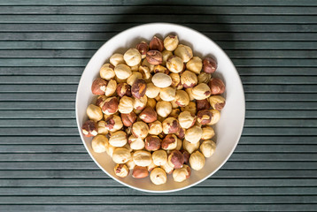 Healthy food  for background image close up hazelnuts.  Nuts texture on top view on the cup plate