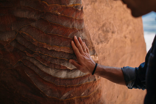 Traveler Touching the Ancient Sandstone Walls of the Treasury in Petra, Jordan