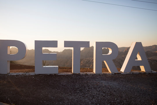 Iconic Petra Letters Landmark at Sunrise or Sunset in Jordan's Desert Landscape