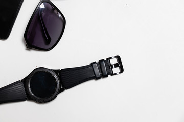 Top view sunglass and men watch on flat lay