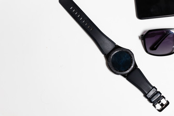 Top view sunglass and men watch on flat lay