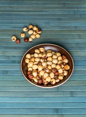 Healthy food  for background image close up hazelnuts.  Nuts texture on top view on the cup plate