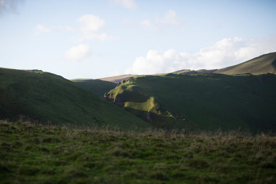 Expansive Green Valleys and Rolling Hills Landscape Under a Soft Cloudy Sky