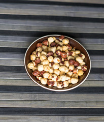 Healthy food  for background image close up hazelnuts.  Nuts texture on top view on the cup plate