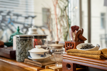 Chinese tea tasting in the tea shop. Chinese tea set, close-up traditional Chinese teapot and cups on bamboo mats