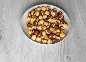 Healthy food  for background image close up hazelnuts.  Nuts texture on top view on the cup plate
