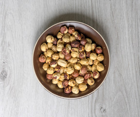 Healthy food  for background image close up hazelnuts.  Nuts texture on top view on the cup plate