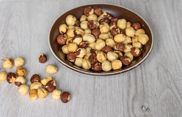 Healthy food  for background image close up hazelnuts.  Nuts texture on top view on the cup plate