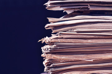 A stack of old newspapers close-up.