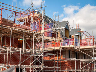 Newly build homes in scaffolding UK