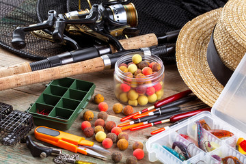 fishing tackle on a wooden table. toned image 