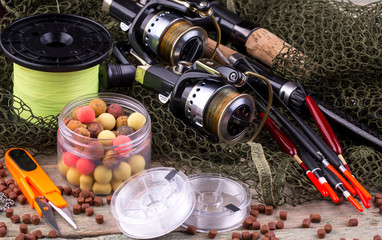 fishing tackle on a wooden table. toned image 