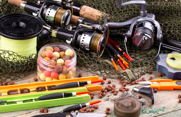 fishing tackle on a wooden table. toned image 