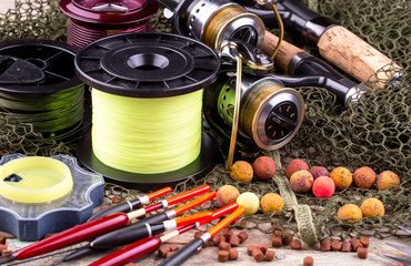 fishing tackle on a wooden table. toned image 