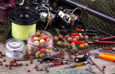 fishing tackle on a wooden table. toned image 