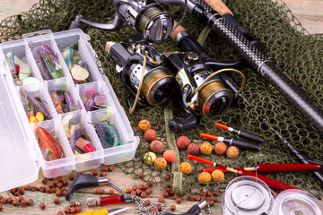 fishing tackle on a wooden table. toned image 