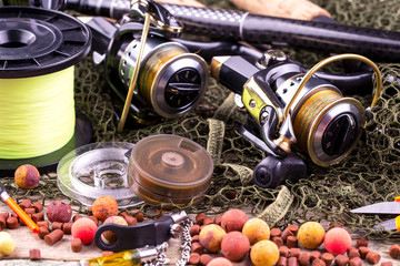 fishing tackle on a wooden table. toned image 