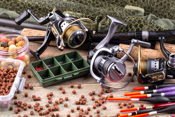 fishing tackle on a wooden table. toned image 