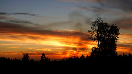 Fototapeta na wymiar Beautiful Sunset during Road Trip in South America with Smoke Clouds 