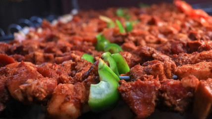 Cooking skewered meat on a grill