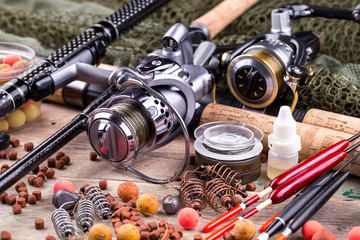 fishing tackle on a wooden table. toned image  © Karnav