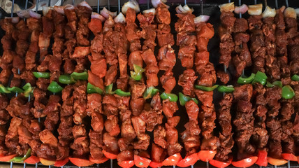 Cooking skewered meat on a grill