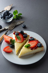 Cheesecake with fresh berries and mint for dessert - healthy organic summer dessert pie cheesecake. Cheese cake. Gray background.
