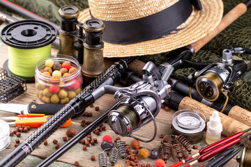 fishing tackle on a wooden table. toned image 