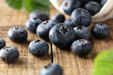 Fresh blueberries, close up on rustic wooden surface. Concept for healthy eating and nutrition.