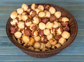 Healthy food  for background image close up hazelnuts.  Nuts texture on top view on the cup plate