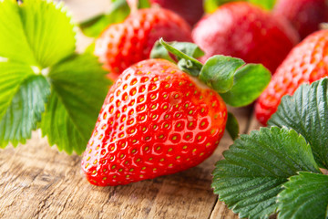 Fresh, tasty summer strawberrie. close up ripe strawberry on wooden board. Summer day light.
