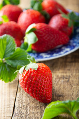 Fresh, tasty summer strawberrie. close up ripe strawberry on wooden board. Summer day light.