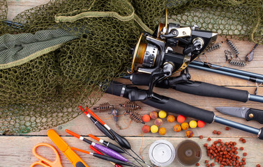 fishing tackle on a wooden table. toned image 