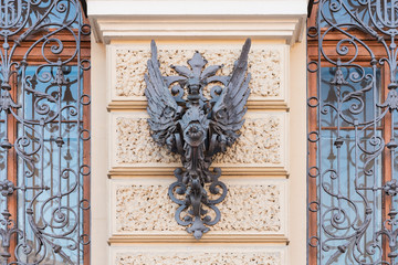 Heraldic symbol forged from iron on an old house in St. Petersburg