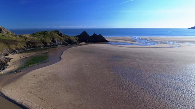 Aerial view of Three Cliffs Bay south coast beach the Gower Peninsula Swansea Wales uk