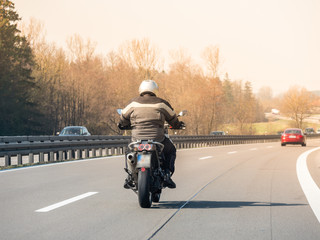 Image of a motorcycle rider on a german highway on high speed