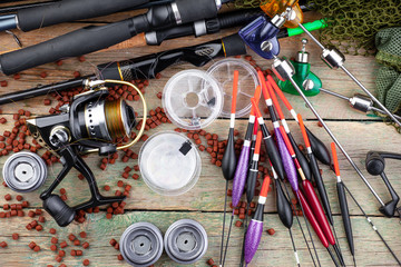 fishing tackle on a wooden table. toned image 