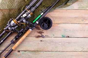 fishing tackle on a wooden table. toned image 