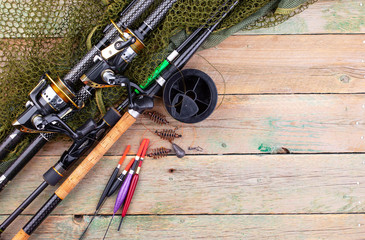 fishing tackle on a wooden table. toned image 