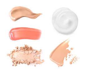 Set with swatches of lipsticks, eye shadows and skin foundations on white background, top view