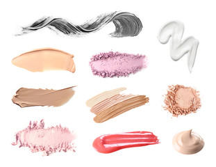 Set with swatches of lipsticks, eye shadows, mascara and skin foundations on white background, top...
