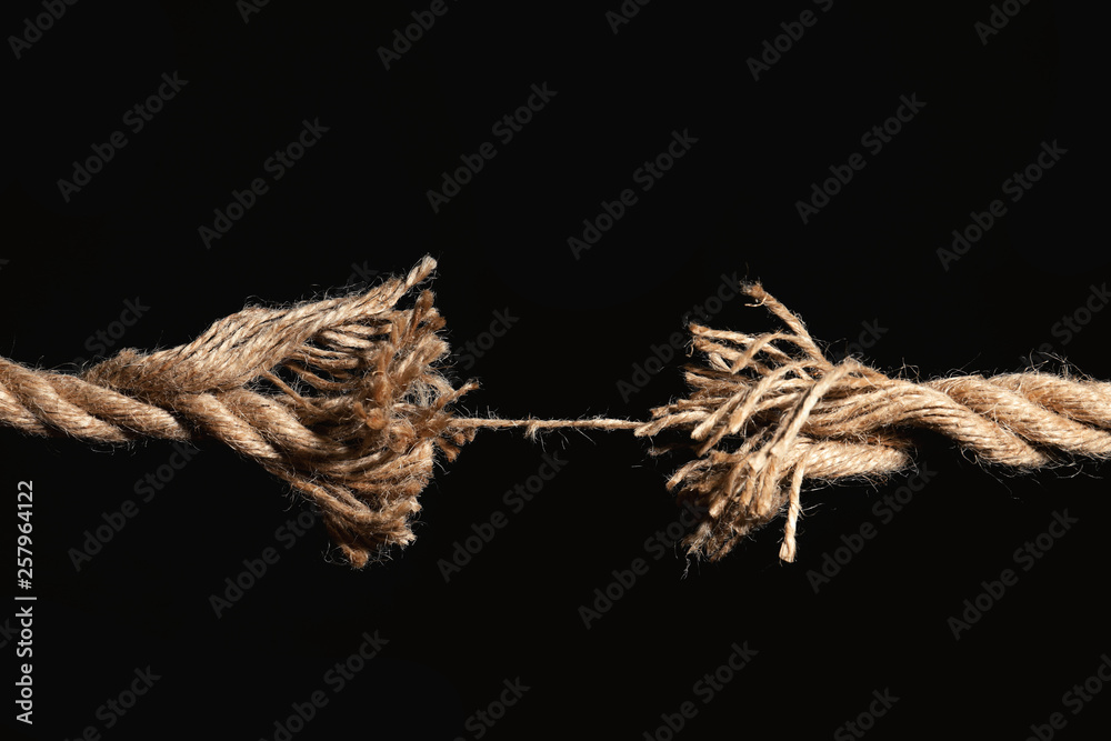 Wall mural Rupture of cotton rope on black background