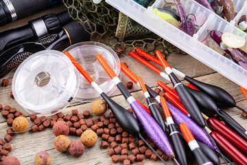 fishing tackle on a wooden table. toned image 
