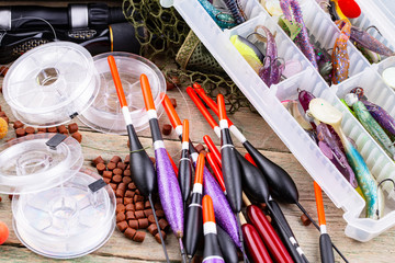 fishing tackle on a wooden table. toned image 