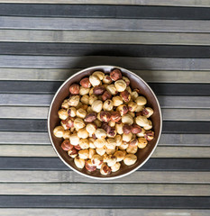 Healthy food  for background image close up hazelnuts.  Nuts texture on top view on the cup plate