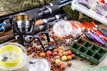 fishing tackle on a wooden table. toned image 