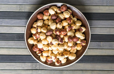 Healthy food  for background image close up hazelnuts.  Nuts texture on top view on the cup plate