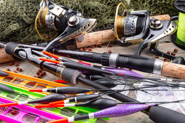 fishing tackle on a wooden table. toned image 