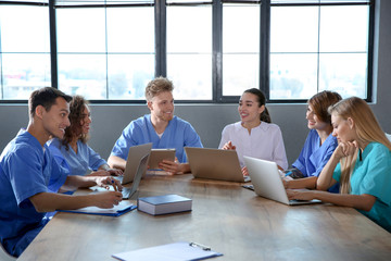 Group of smart medical students with gadgets in college